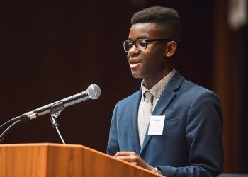 Professional African businessman holding a microphone presenting